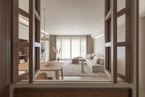 A modern minimalist living room with a cozy arrangement of furniture and a neutral color palette.