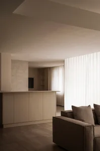 Modern living room with neutral-colored furniture and a minimalistic design.