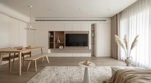 A minimalist living room featuring a wall-mounted television, wooden furniture, and beige accents.