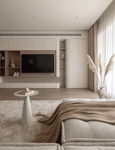 A minimalist living room with neutral colors and a modern aesthetic, featuring a couch, coffee table, and decorative elements