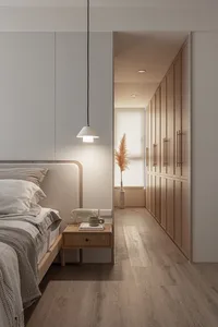 A minimalist bedroom featuring a wooden bed and glass wardrobe with textile bedding and a pendant light fixture.