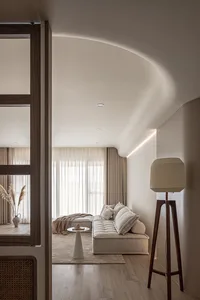 Cozy living room featuring neutral-toned furniture and decor, minimalist design, and ample natural light.