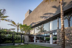 A modern house featuring concrete and glass exterior materials.