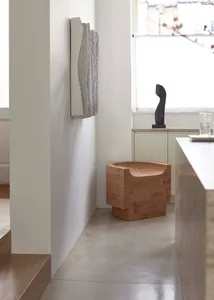 A modern residential kitchen with wood and concrete materials.
