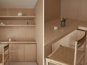 A minimalist workspace featuring wooden shelves and furniture.