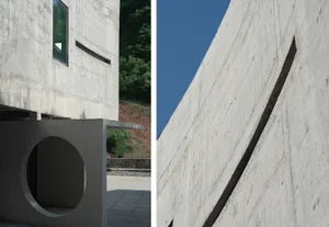 Modern architecture featuring concrete walls and circular openings.