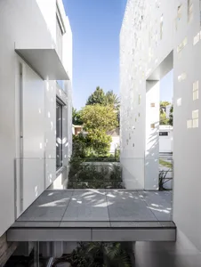 Modern architectural design featuring a glass exterior with tiled and concrete elements.