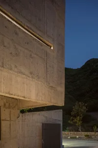Image of a modern building exterior with a concrete wall.