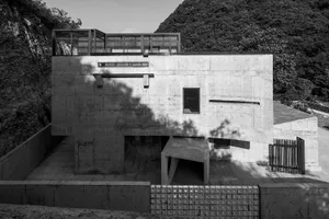Modern residential house constructed primarily of concrete materials, featuring clean lines and a minimalist design.