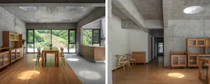 Modern minimalist residential interior featuring wooden furniture and concrete walls.