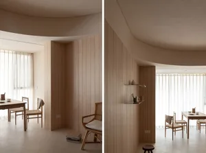 A minimalist interior design featuring wooden walls and furniture, with a focus on natural elements and clean lines.
