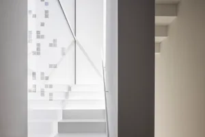 A minimalist white interior with modern architectural features.