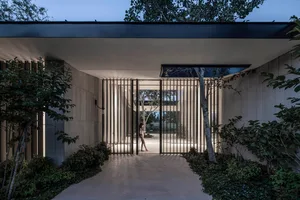 Modern entrance with metal railings and a path.