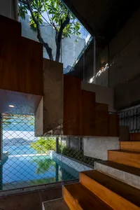 Modern interior space featuring glass walls and a view of the ocean.