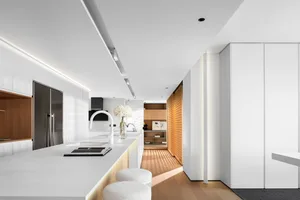 Modern kitchen featuring clean lines, white countertops, wooden accents, and stainless steel appliances.