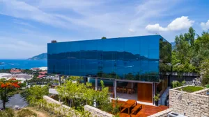 A modern glass residential building with panoramic ocean views.
