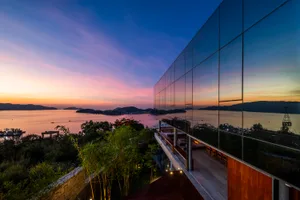 Modern residential exterior featuring a glass wall