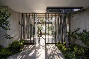Modern glass entrance with a person running inside.