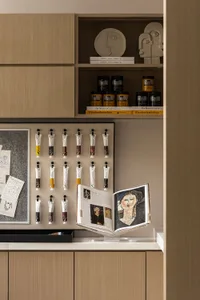 Art supply storage unit featuring minimalist design with wood material and various acrylic paints arranged neatly on shelves.