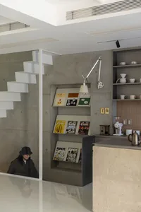 Industrial-style kitchen with concrete walls and minimalist design.