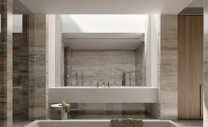 Modern bathroom with marble walls and floor, featuring a large bathtub and a freestanding faucet.