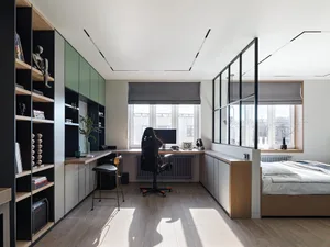 A modern bedroom featuring glass windows, a desk, and a bed.