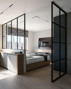 Modern bedroom with a glass and metal wall, wooden flooring, and a bed with white bedding.