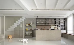A modern coffee shop interior with concrete and glass materials.