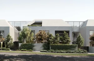 Modern residential building with a combination of concrete and glass materials.