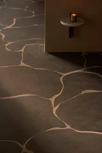 A modern interior space featuring stone floor tiles with a natural, irregular pattern.