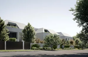 A modern residential exterior with concrete walls and a sloped roofline, surrounded by green foliage and a well-maintained la
