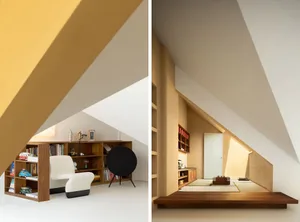 A minimalist room with wooden furniture and shelves, featuring a white chair and a black speaker.
