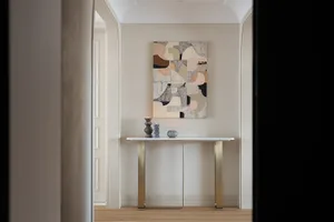 A modern console table adorned with contemporary abstract art in a minimalistic interior
