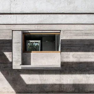 Concrete window with minimalist framing on a modern exterior wall