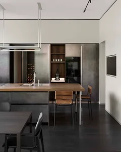 Modern residential kitchen featuring wooden countertops and metal cabinets.