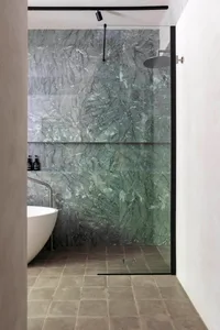 Modern bathroom featuring marble walls and floor