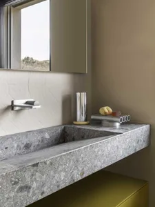 Modern bathroom design featuring a terrazzo sink countertop with minimalist hardware.
