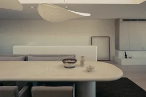 A modern living room with concrete furniture and minimalist design.
