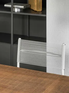 A modern, white desk with a metal frame designed for a home office.