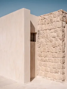 Modern exterior wall made of concrete and stone materials.