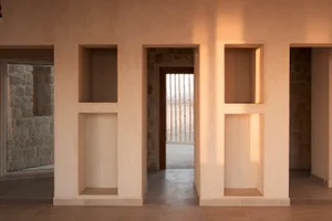 Modern interior design featuring concrete and stone materials.
