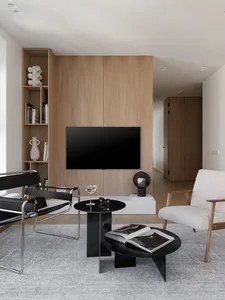A modern industrial living room featuring wood elements and minimalist design.