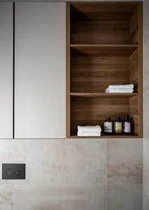 Minimalist bathroom featuring wooden shelves and ceramic tiles.