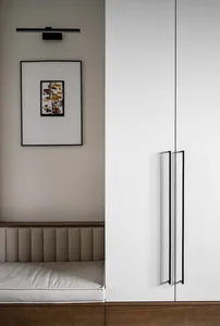 Modern minimalist artwork with metal handles mounted on a wall.