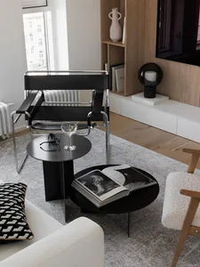 A modern minimalist living room featuring wooden tables and minimalist furniture.