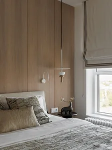 A modern bedroom featuring minimalist lighting and a cozy atmosphere.