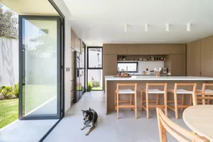 A modern kitchen featuring wooden cabinets and a white countertop.