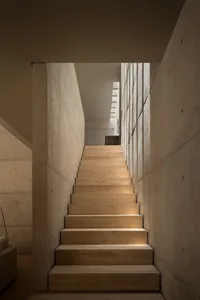 A minimalist staircase made of concrete materials.
