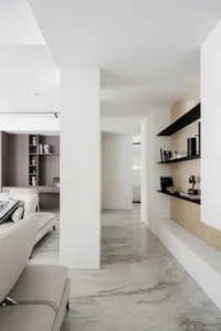 A minimalist interior design featuring concrete and marble materials.