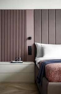 Modern bedroom with a velvet headboard and pink vertical paneling
